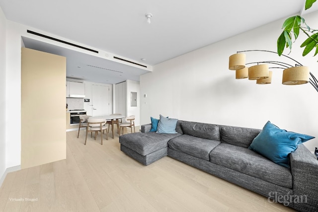 living room with light wood finished floors and electric panel