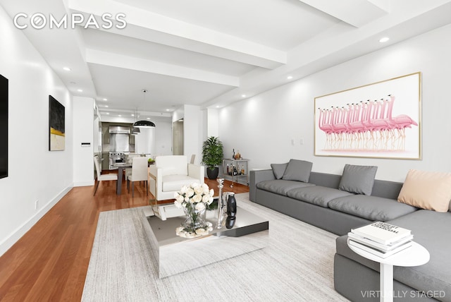 living room featuring baseboards, wood finished floors, and recessed lighting