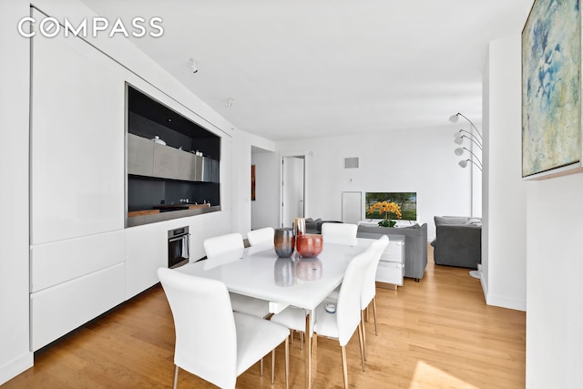 dining room featuring visible vents and light wood-type flooring