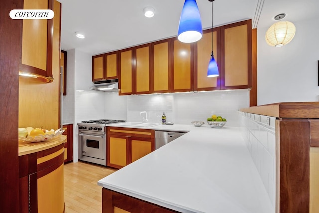 116 Pinehurst Ave Unit G33, New York City, NY 10033 - kitchen featuring appliances with stainless steel finishes, a sink, under cabinet range hood, and backsplash