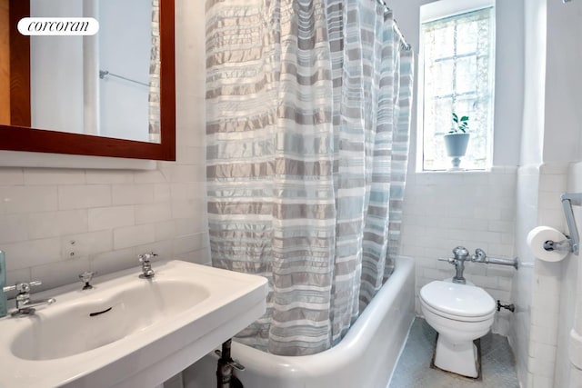 116 Pinehurst Ave Unit G33, New York City, NY 10033 - bathroom featuring tile walls, a sink, toilet, plenty of natural light, and shower / tub combo