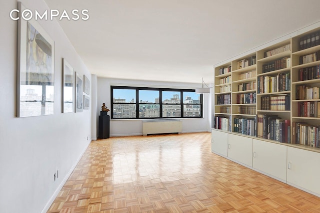 spare room featuring a city view and baseboards