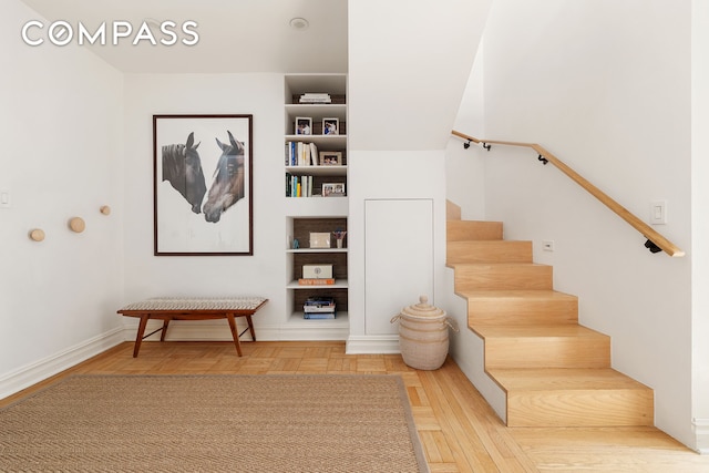 250 W 24th St Unit 6/5Ce, New York City, NY 10011 - stairway with baseboards and built in shelves