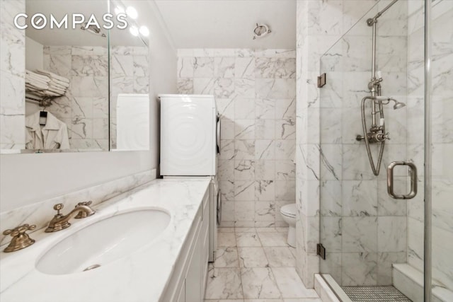 full bathroom featuring toilet, tile walls, vanity, marble finish floor, and a shower stall