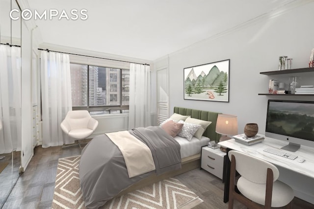 bedroom featuring ornamental molding and dark wood-style flooring