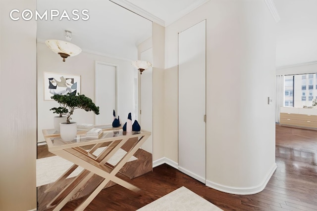 corridor featuring baseboards, dark wood-type flooring, and crown molding