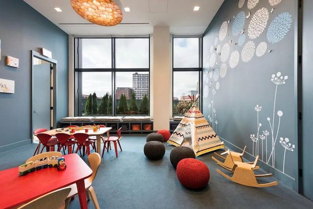 recreation room with a view of city and carpet floors