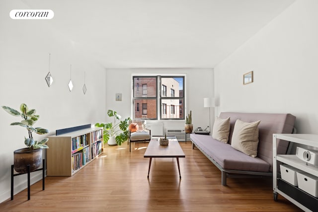 living area featuring visible vents and wood finished floors