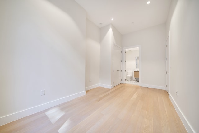 empty room featuring recessed lighting, light wood-style floors, and baseboards