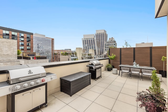 view of patio with a city view and area for grilling