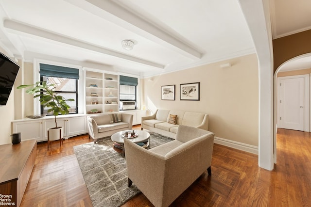 living room featuring ornamental molding, arched walkways, beamed ceiling, and baseboards