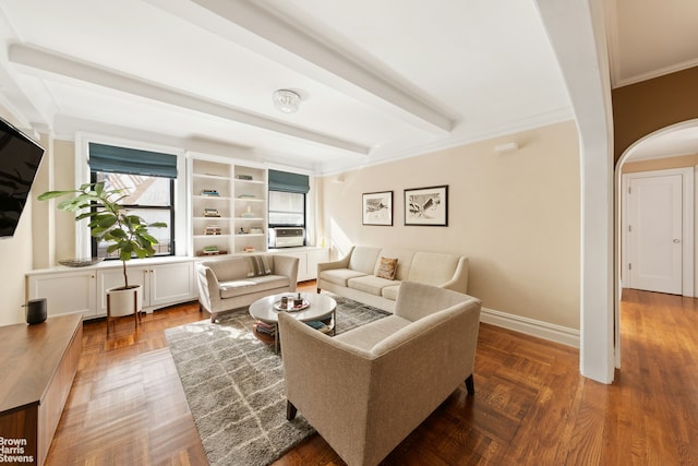 living area with baseboards, arched walkways, beam ceiling, and crown molding