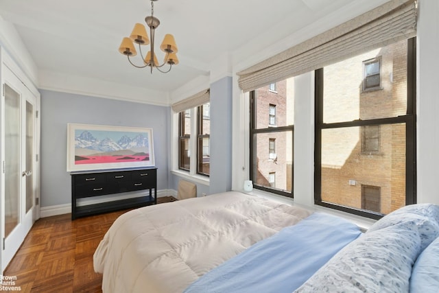 bedroom with baseboards and an inviting chandelier