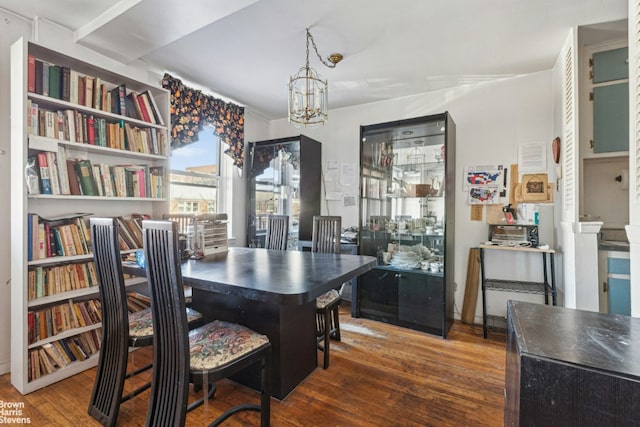 dining room featuring an inviting chandelier and dark wood-style flooring