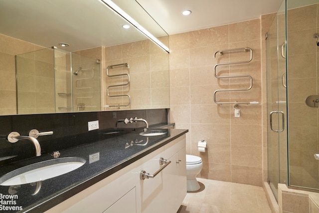 60 E 55th St Unit 15D, New York City, NY 10022 - bathroom with tile walls, a stall shower, double vanity, tile patterned flooring, and recessed lighting