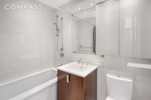 full bath featuring  shower combination, toilet, tile walls, and vanity