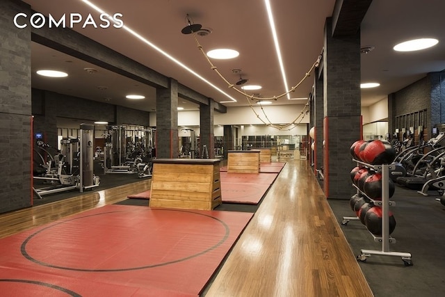 exercise room featuring wood finished floors