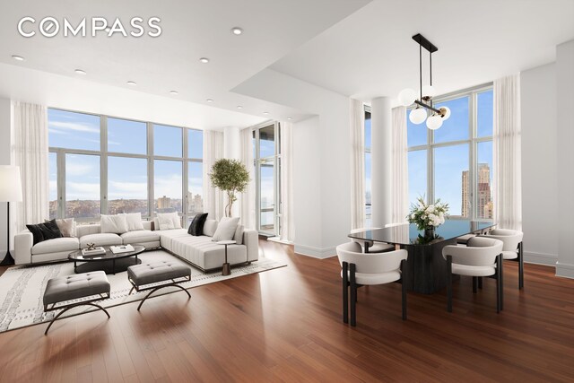 living area featuring a city view, dark wood-style flooring, and a notable chandelier