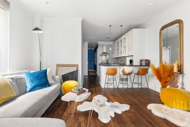 living area with dark wood-style floors and ornamental molding