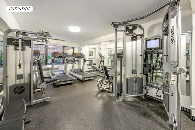 gym featuring an AC wall unit and visible vents
