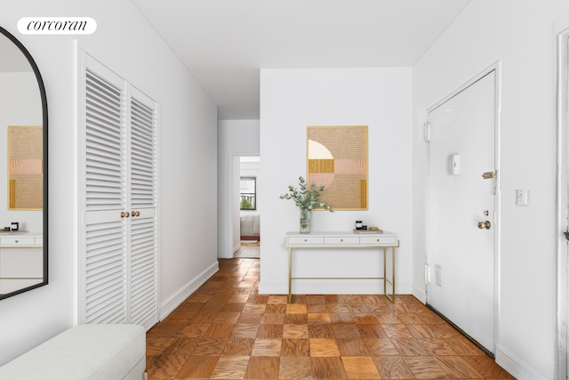 hall featuring visible vents and baseboards