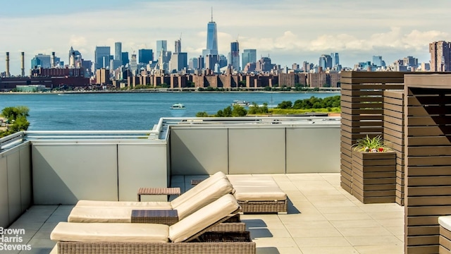 exterior space with a water view, a balcony, and a city view