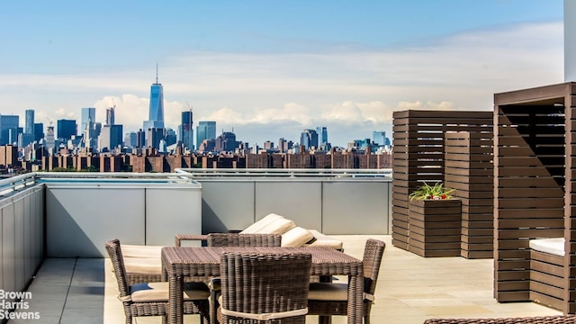 view of patio / terrace with a view of city, outdoor dining area, and a balcony