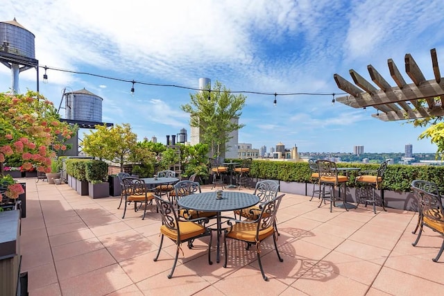 view of patio / terrace with outdoor dining area and a city view