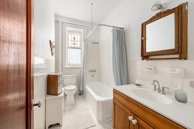 645 W End Ave Unit 9C, New York City, NY 10025 - full bathroom featuring tile walls, vanity, shower / bath combo with shower curtain, toilet, and tile patterned flooring