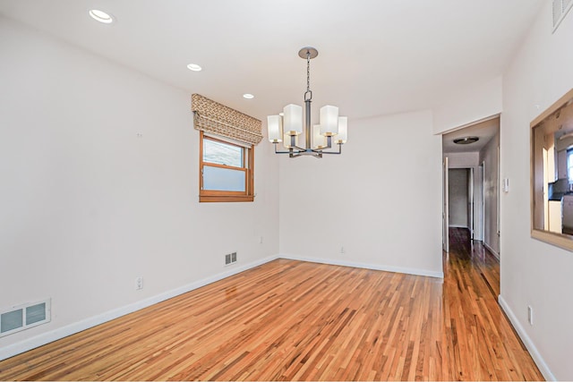 spare room with light wood-type flooring, visible vents, baseboards, and recessed lighting