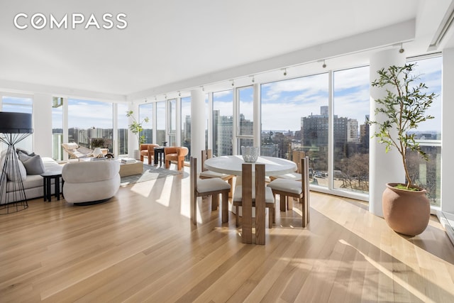 sunroom / solarium featuring a view of city