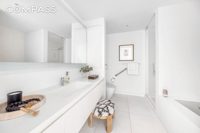 bathroom with a stall shower, tile patterned flooring, vanity, and toilet