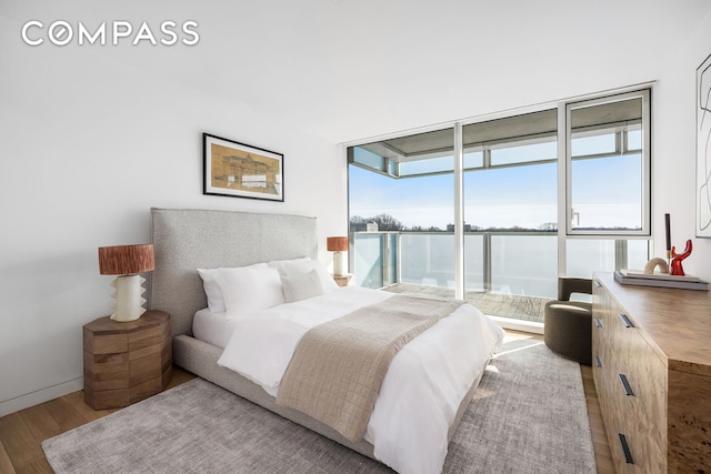 bedroom with baseboards and wood finished floors