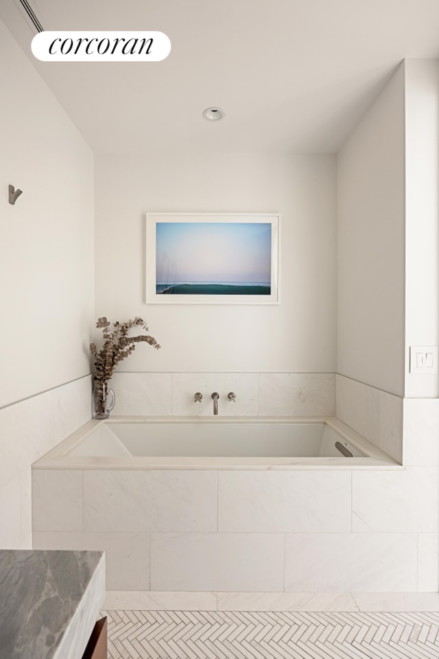 full bathroom with tile patterned flooring and a bath