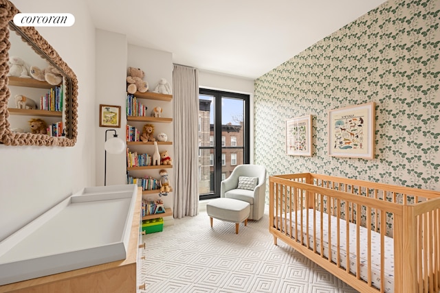 bedroom with a crib, visible vents, and wallpapered walls