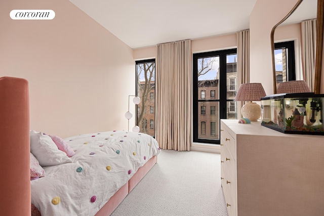 bedroom with lofted ceiling, visible vents, and light colored carpet