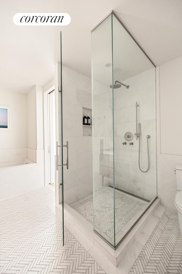 full bath featuring a stall shower, tile patterned flooring, and toilet