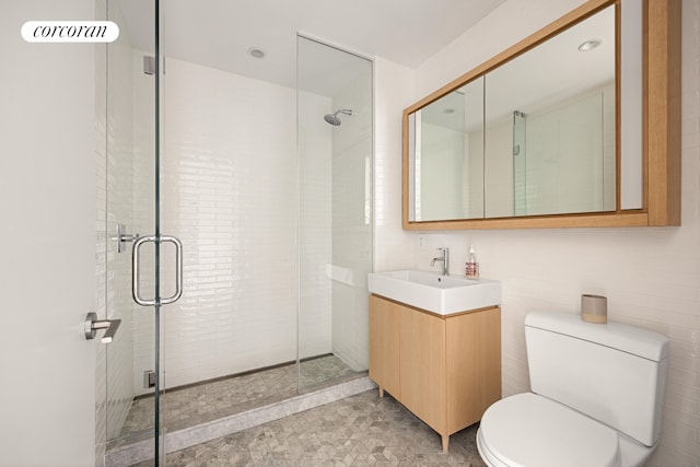 full bathroom with toilet, a shower stall, and vanity