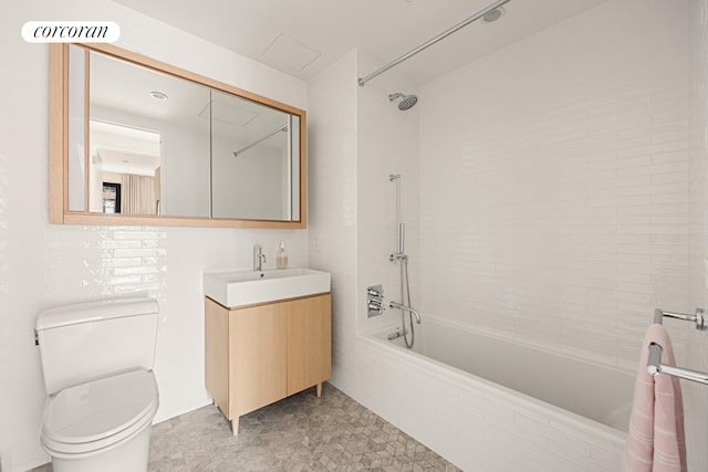 bathroom with tiled shower / bath, visible vents, vanity, and toilet