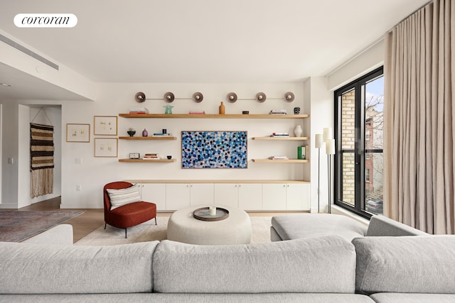 living area with light wood finished floors and visible vents