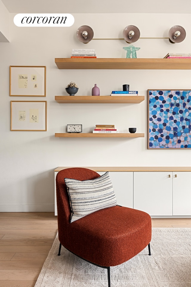 living area with light wood-type flooring and baseboards