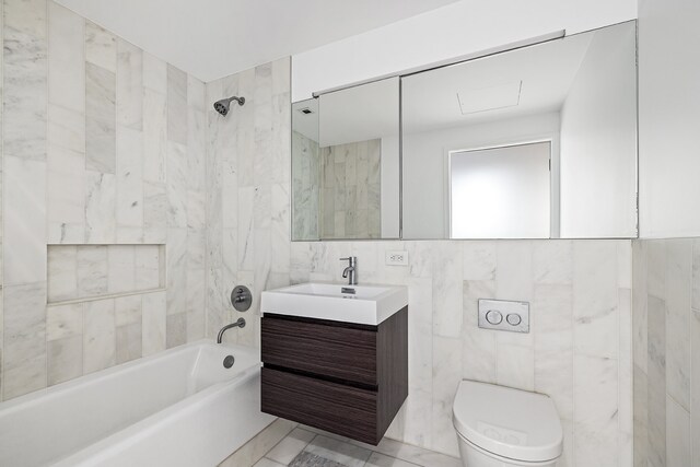 bathroom with  shower combination, toilet, tile walls, and vanity