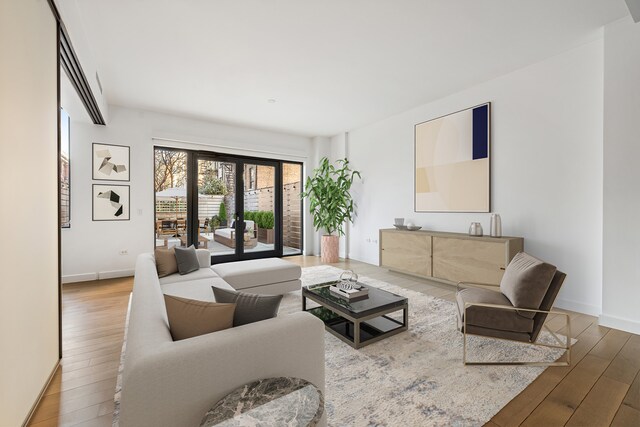 150 Rivington St Unit 2H, New York City, NY 10002 - living room with baseboards and wood finished floors