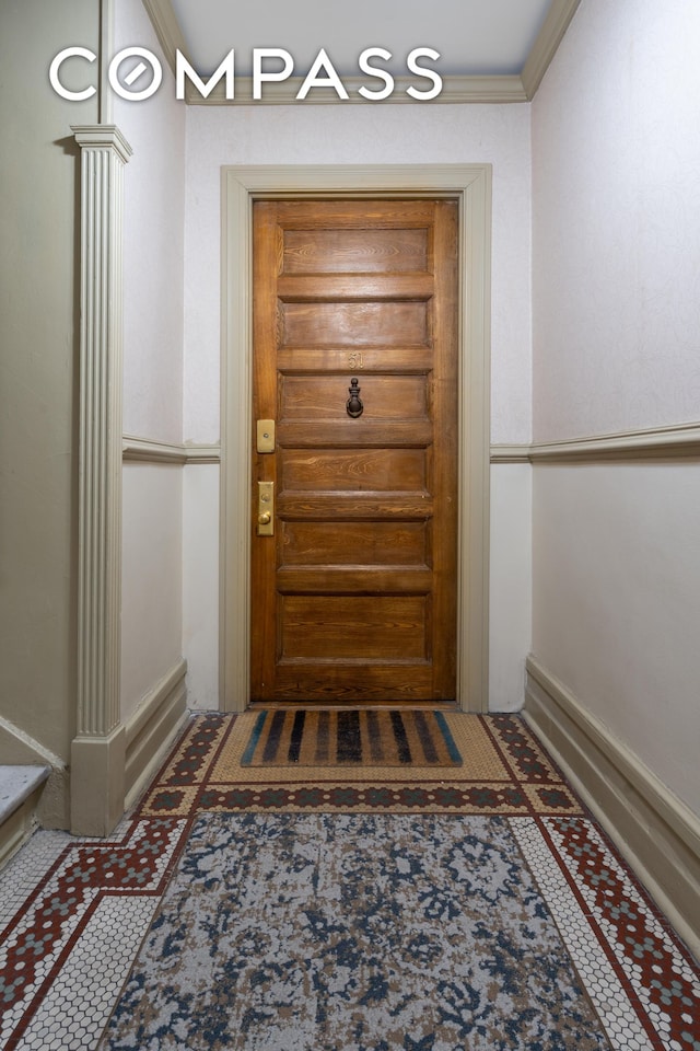 interior space with ornamental molding and ornate columns