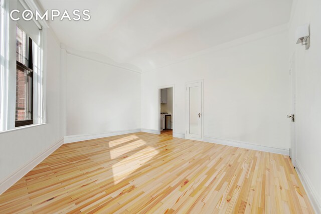 unfurnished room featuring light wood-type flooring and baseboards