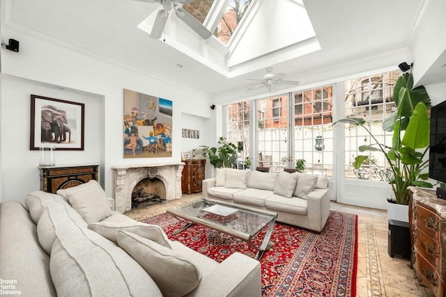 living area with crown molding, ceiling fan, and a fireplace