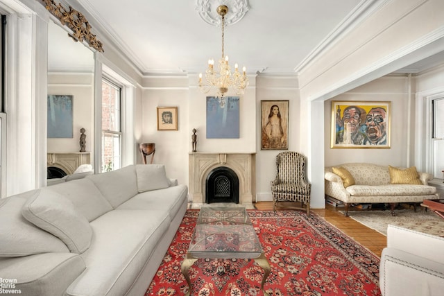 living area featuring a chandelier, a fireplace, and ornamental molding