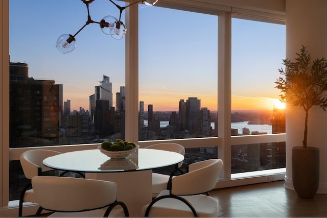 sunroom / solarium with a view of city and a chandelier