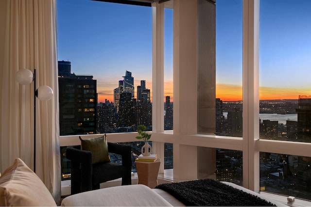 bedroom featuring a wall of windows and a view of city