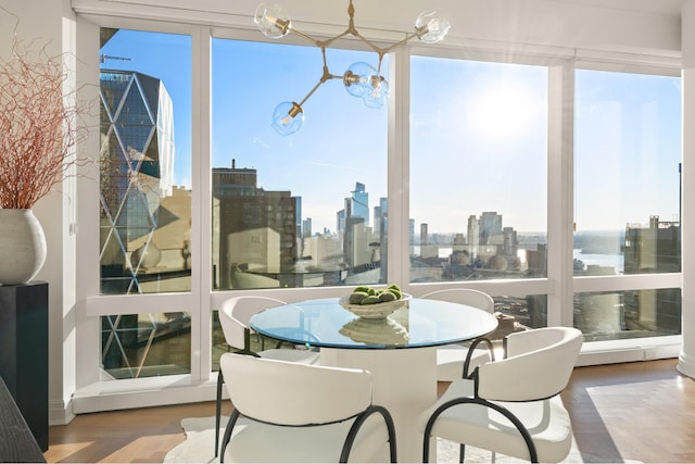 sunroom / solarium featuring a notable chandelier and a city view